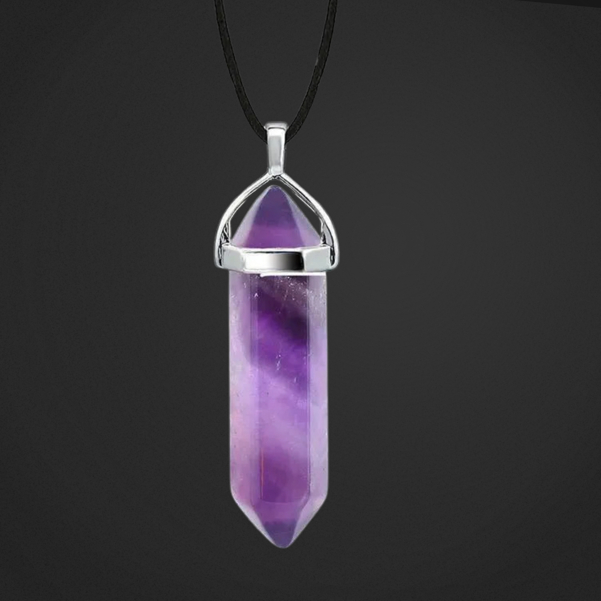 Amethyst crystal pendant with silver top on a black background