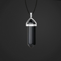 Black crystal pendant on a black cord against a dark background