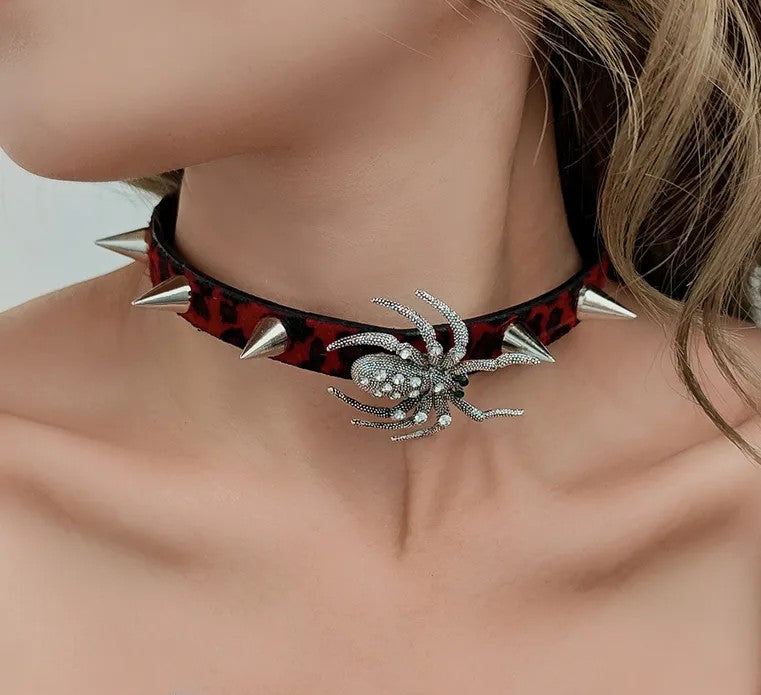 Spiked choker with spider accessory on a womans neck. White background