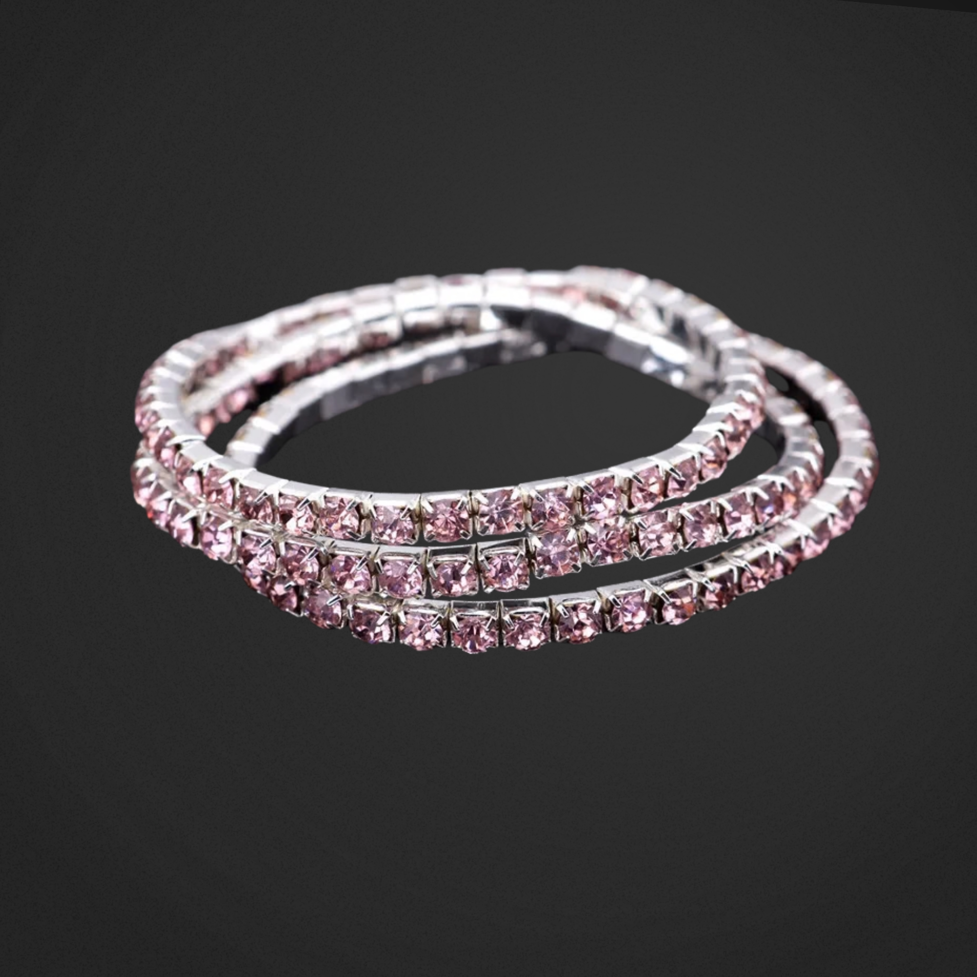 Pink and silver bracelet on a black background