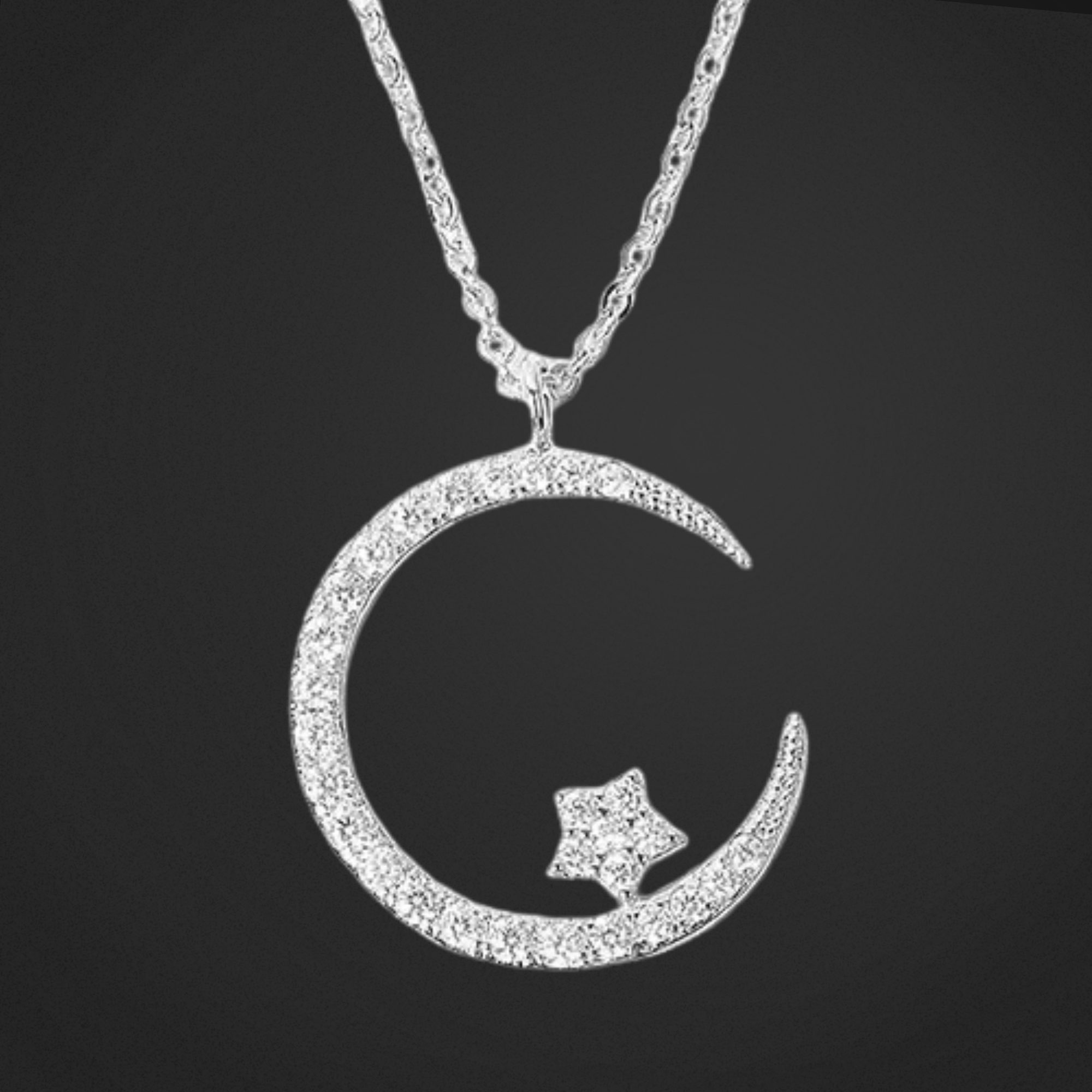 Silver moon and star pendant necklace on a black background