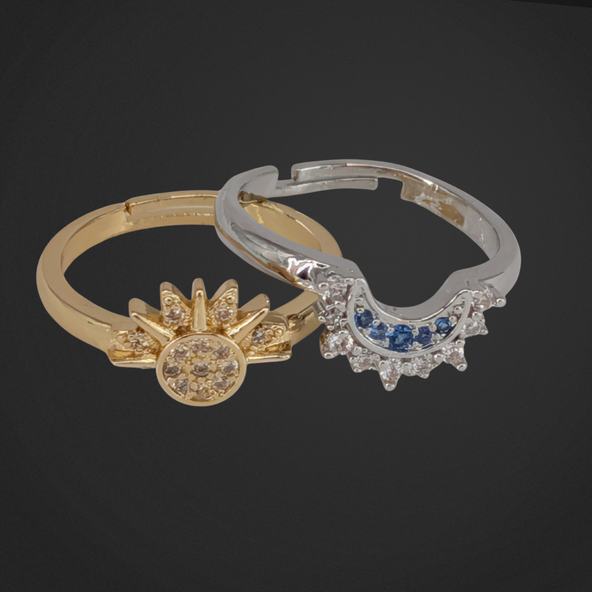 Two gold and silver rings with intricate designs on a black background