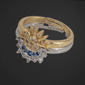 Image of two rings sitting on one another. one is half a moon, other is half a sun. The moon is silver and the sun is gold. Both have small gems.
