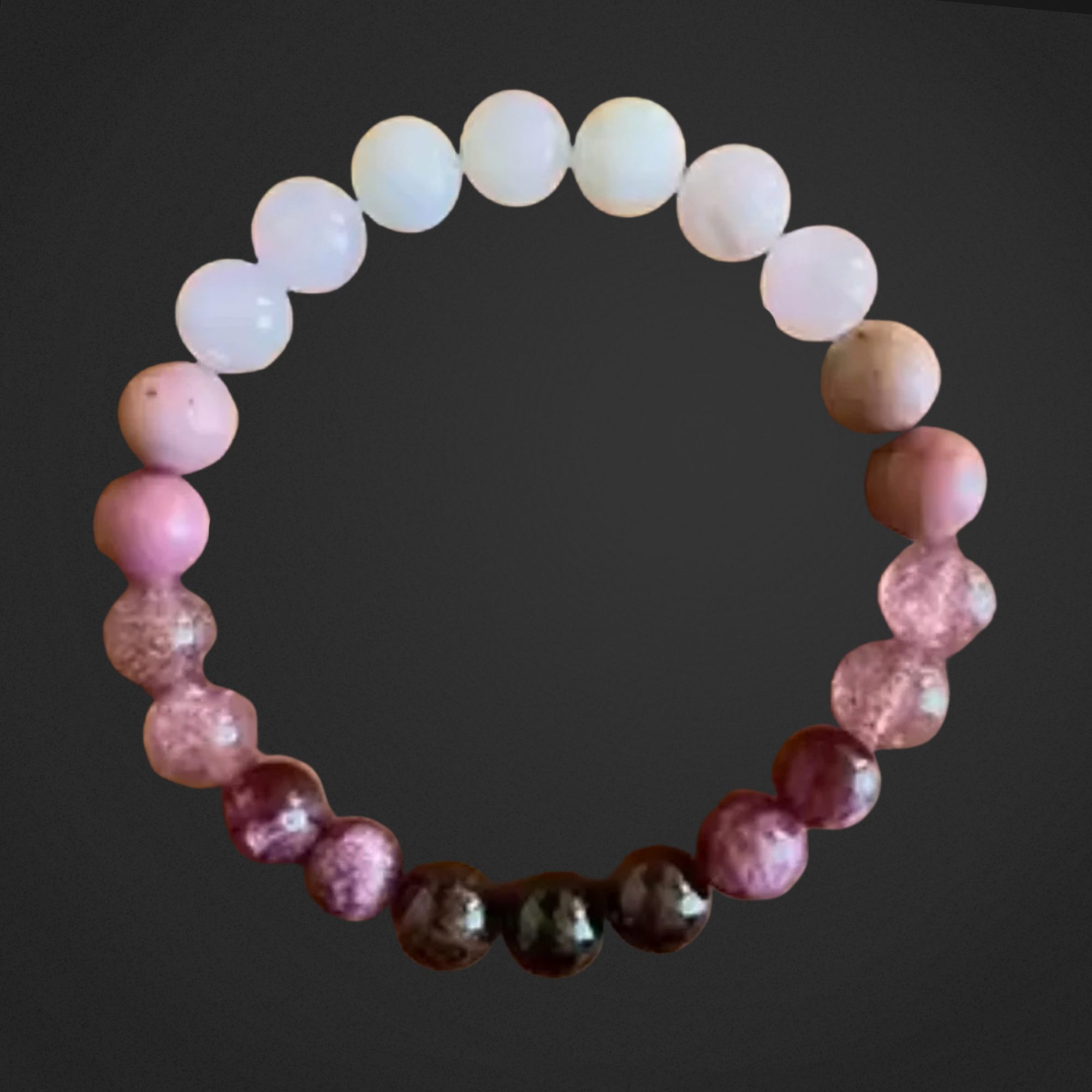 Beaded bracelet with pink, white, and brown beads on a dark background