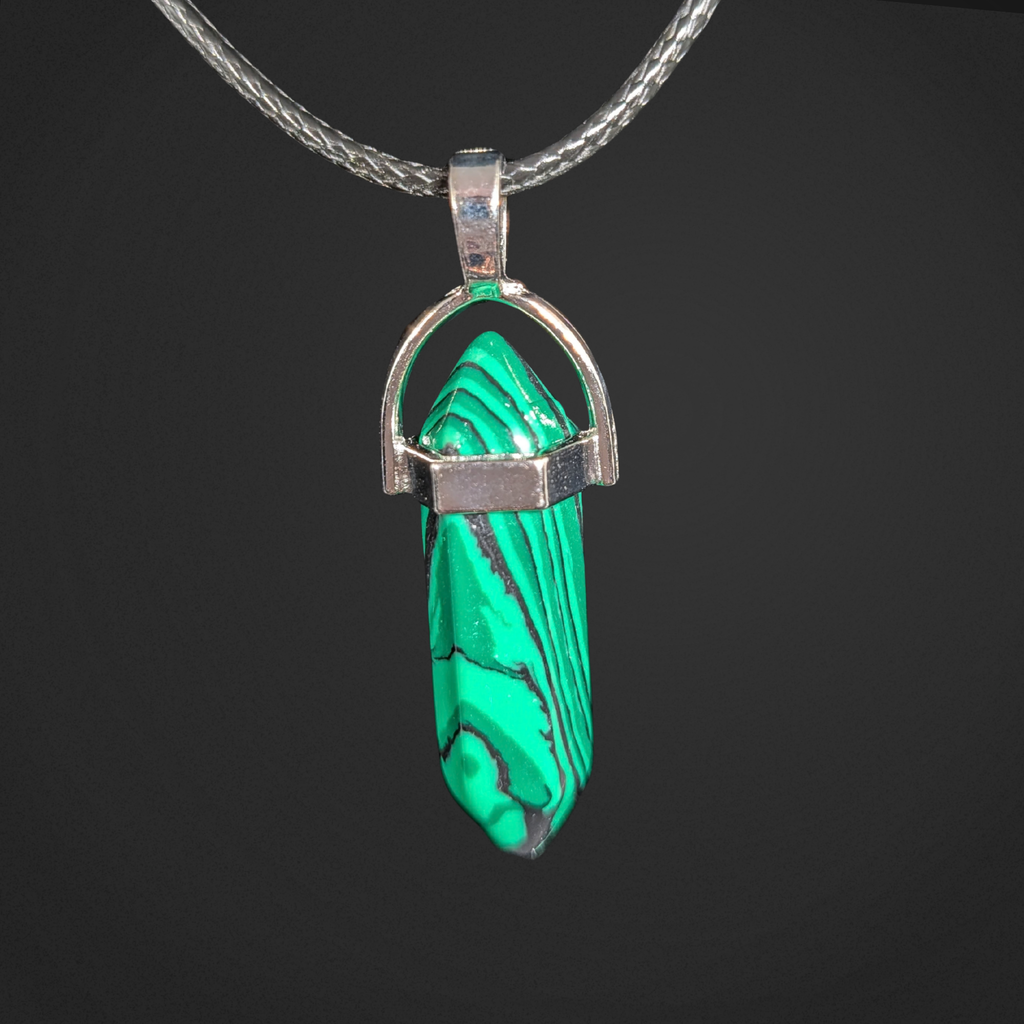 Green stone pendant on a silver chain against a black background