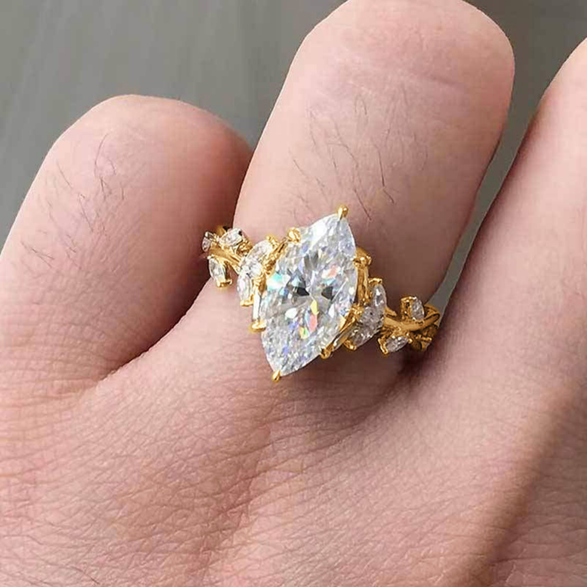 Gold ring with a large diamond on a finger