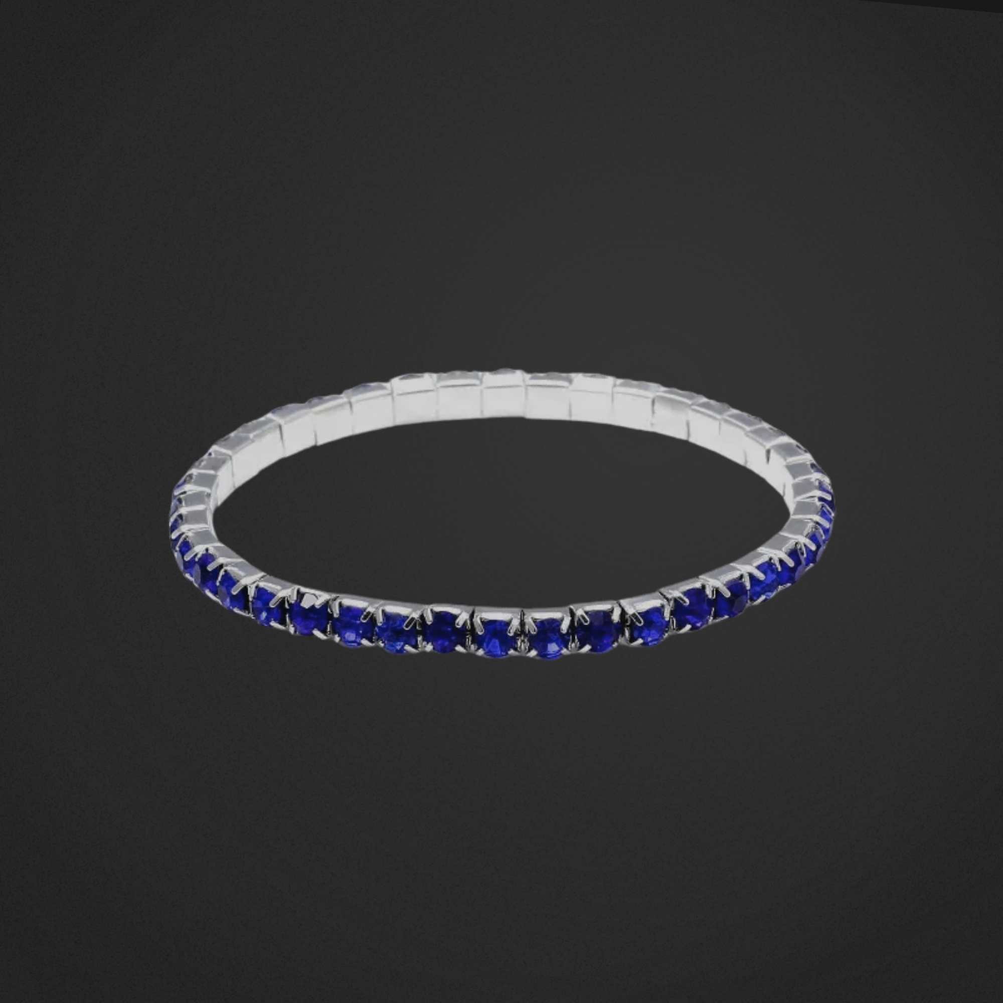 Silver bracelet with blue stones on a black background