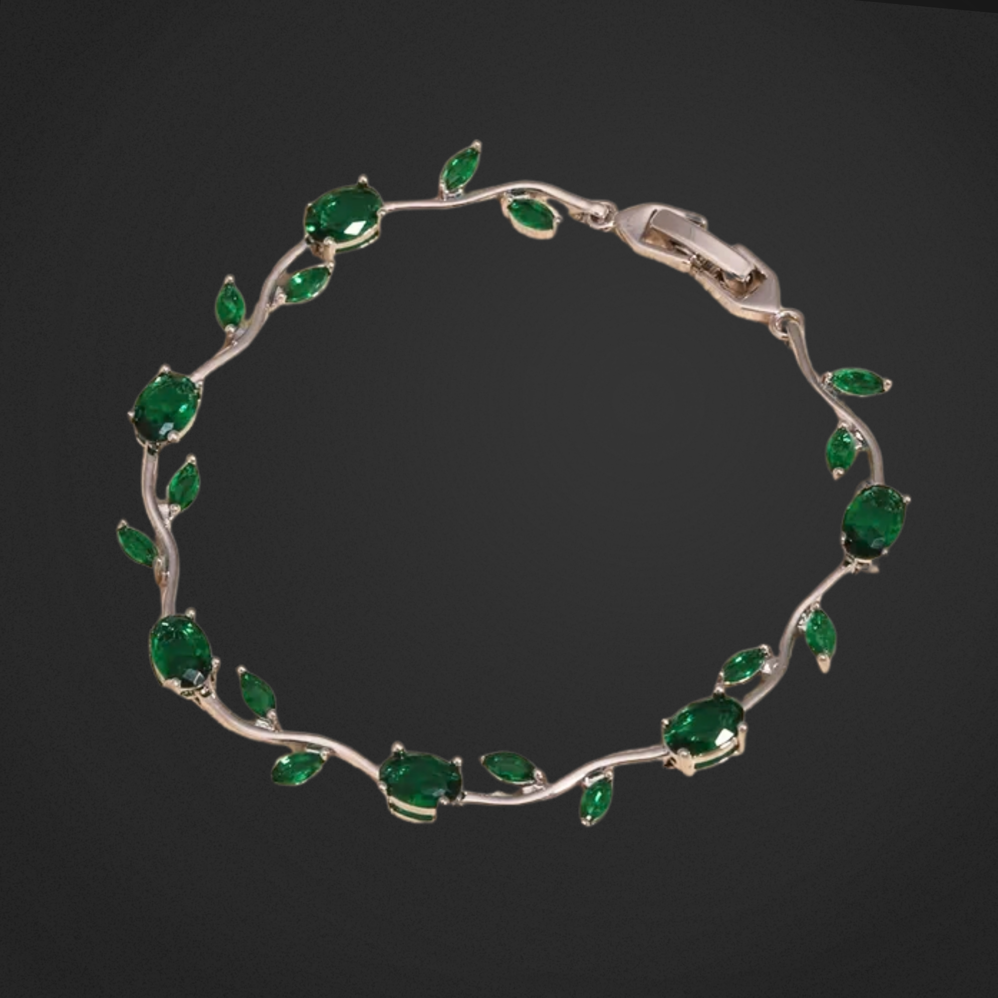 Silver bracelet with green gemstones on a black background