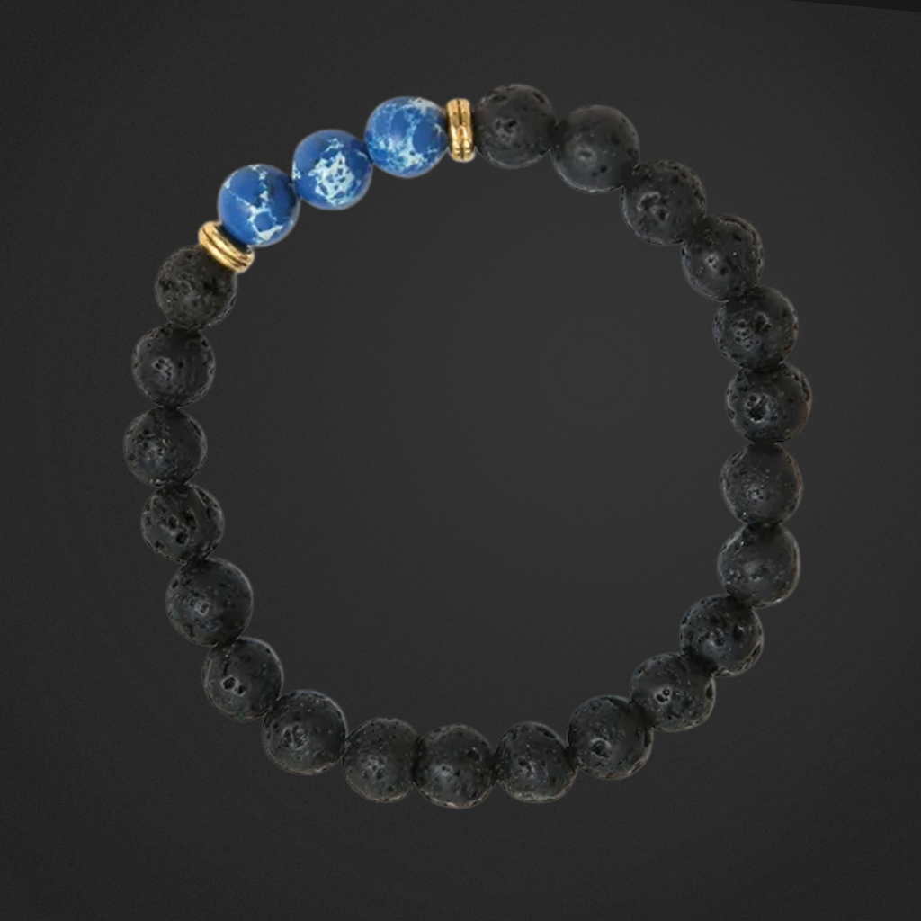 Black beaded bracelet with blue and gold accents on a dark background