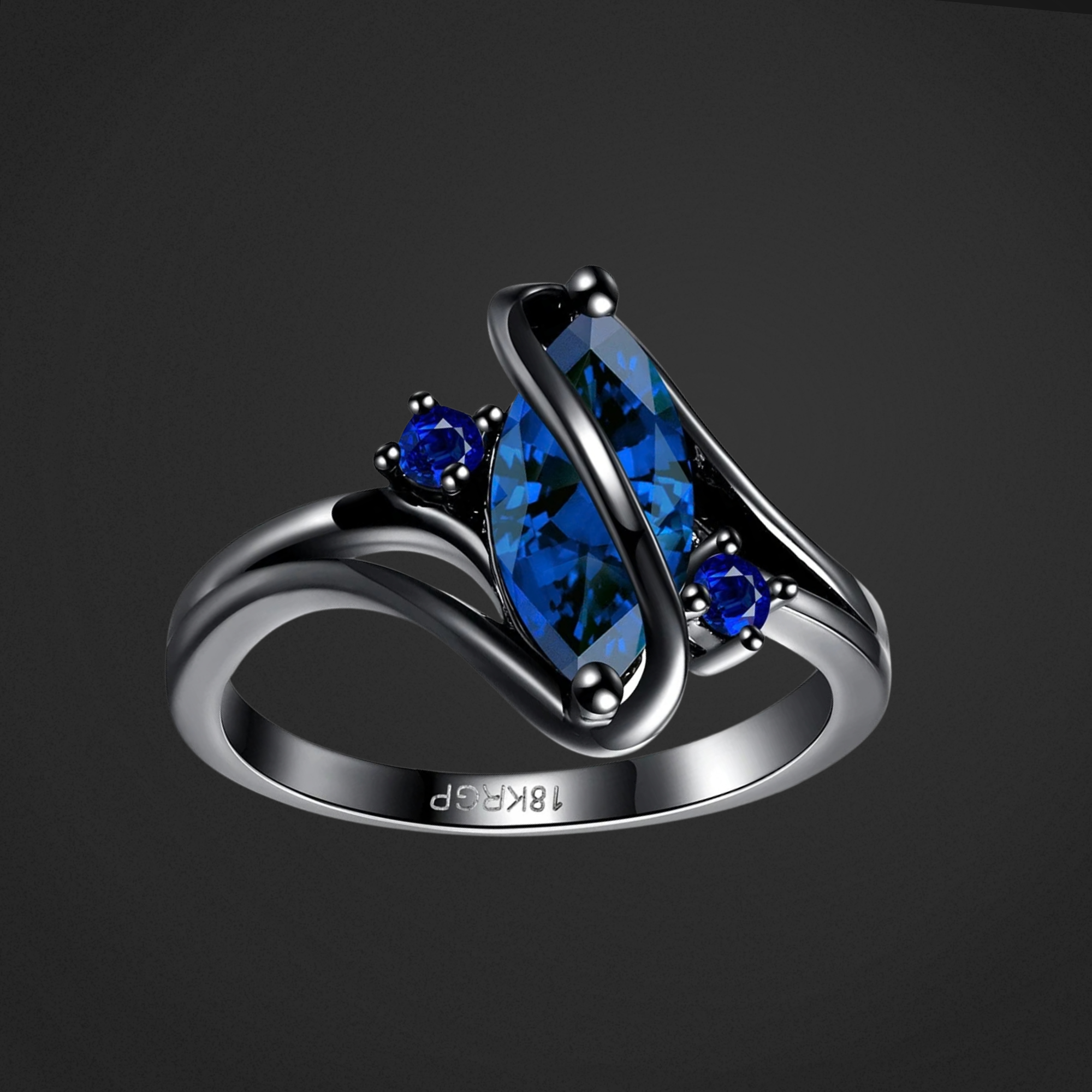 Silver ring with blue gemstones on a black background
