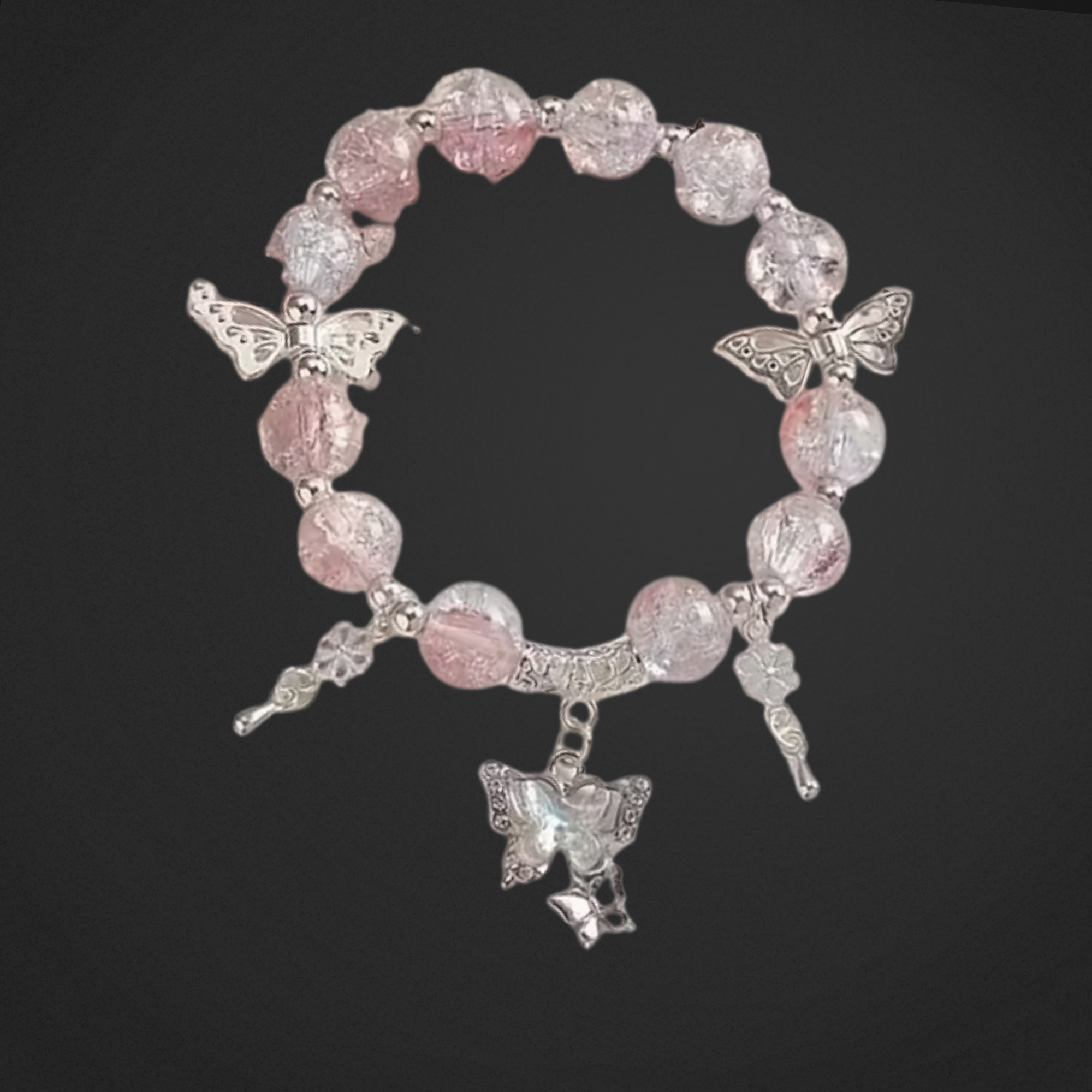 Bracelet with pink beads and silver butterfly charms on a black background
