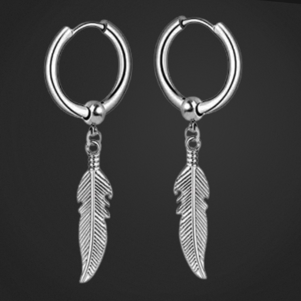 Pair of silver hoop earrings with feather charms on a black background