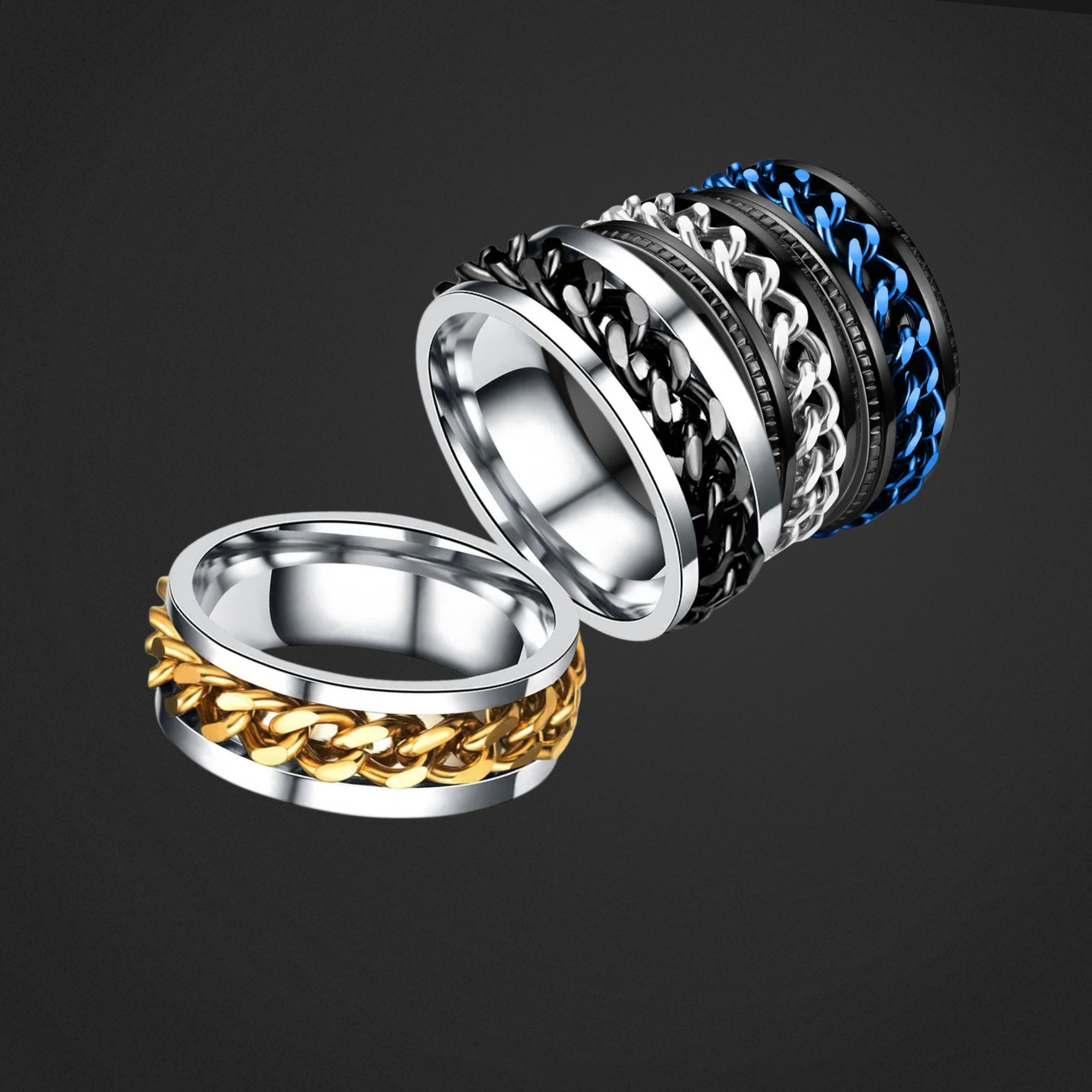 Four metallic rings, 2 are silver with chains and two are black with chains on a black background