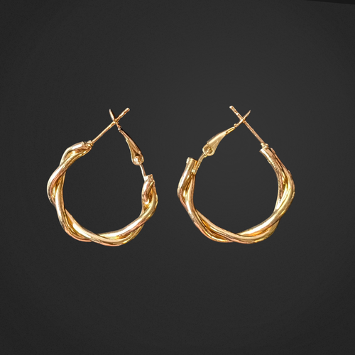 Pair of gold hoop earrings on a black background