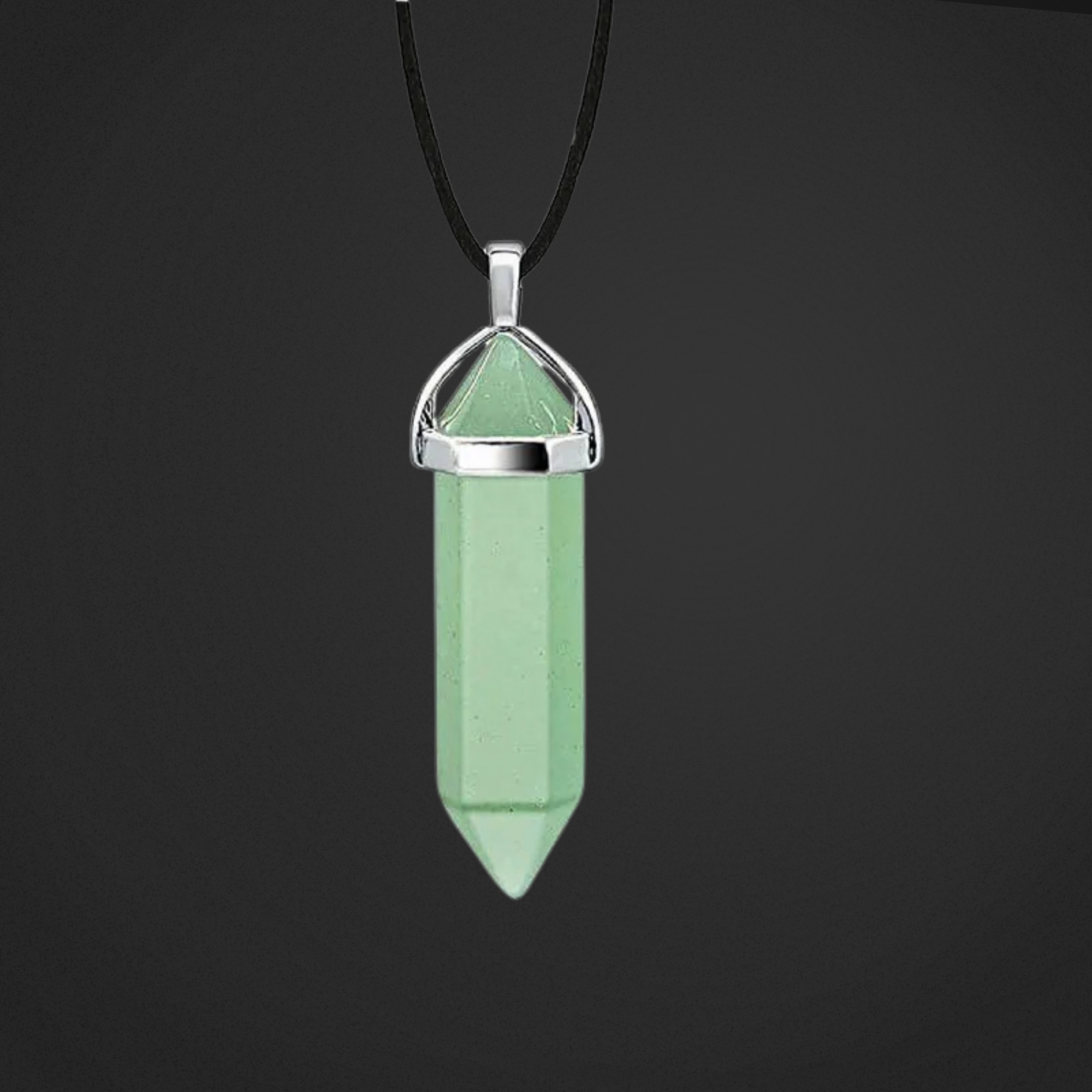 Green crystal pendant on a black background