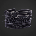 Stack of black leather bracelets with buckles on a dark background
