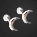 Silver moon-shaped earrings on a black background