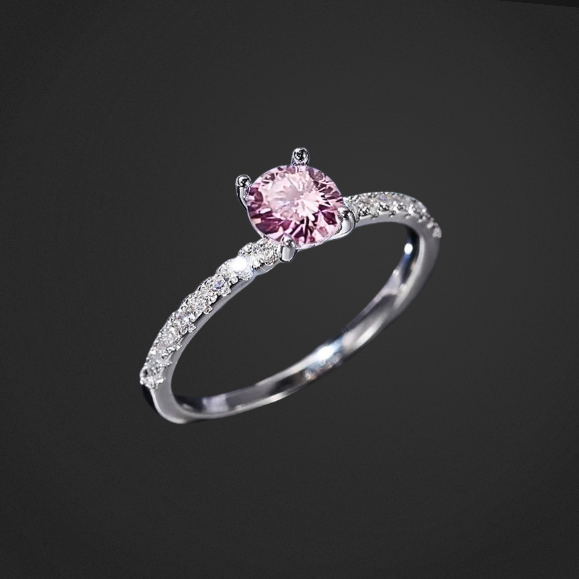 Silver ring with a pink gemstone on a black background